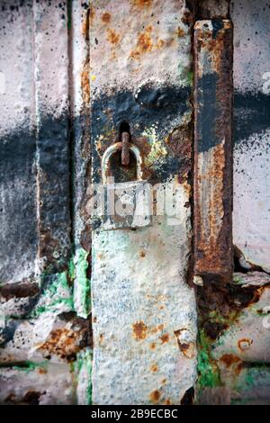 Padlock on Grungy Rusty Gate Stock Photo