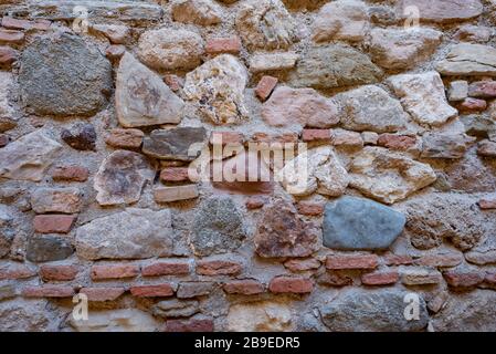Stone and brick wall of an ancient building. Suitable as wallpaper pattern. Stock Photo