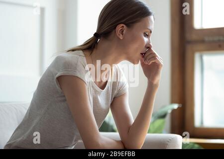 Profile upset pensive woman lost in thoughts, sitting alone Stock Photo