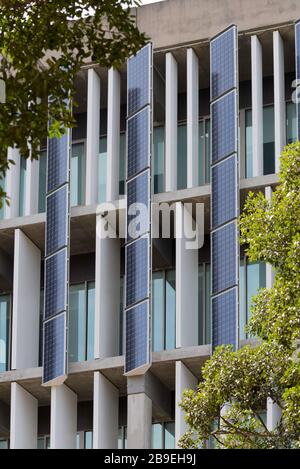 Adjustable or moveable vertical solar panels on the side of a TAFE campus building in the Sydney suburb of Artarmon, New South Wales, Australia Stock Photo