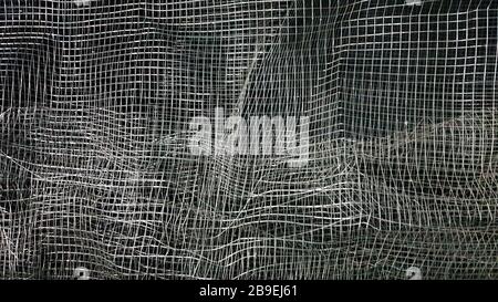 Crumpled mesh. Abstract background. Metal mesh with shadow on a black  background. The surface of a large roll is damaged by wire mesh. 4536388  Stock Photo at Vecteezy