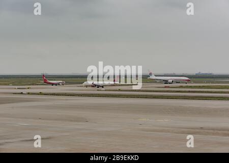 Shanghai, China - May 14, 2019: holding apron of Shanghai Pudong International Airport, airplanes of various airlines are waiting to take off. Stock Photo