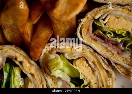 Freshly made omelette rolls in the plate on the table Stock Photo