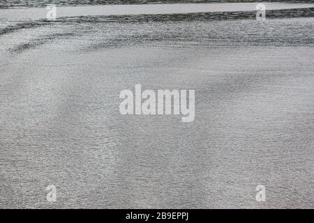 Soft waves on the sea. Water surface background. Reflection Stock Photo