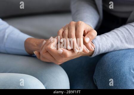 Close up of mom and daughter holding hands Stock Photo