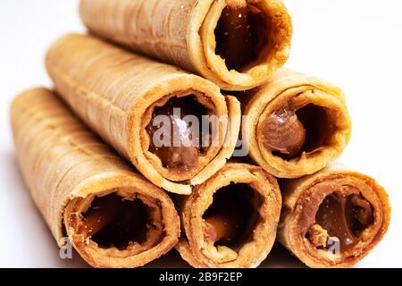 Wafer rolls with condensed milk on white background Stock Photo