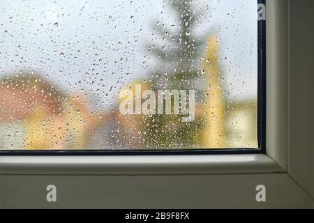 Blurred view on a rainy day through the window. Raindrops on the glass window Stock Photo