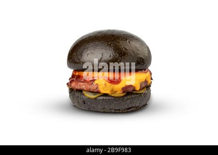 Modern black burger with cutlet, cream cheese, pickles and ketchup Stock Photo