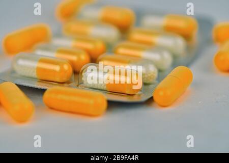 Assorted pharmaceutical medicine pills and capsules. Pills background. Heap of assorted various medicine tablets and pills different colors on white b Stock Photo