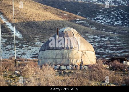 The ancient dwelling of the peoples of Asia is a yurt. In the mountains in winter. snow landscape Stock Photo