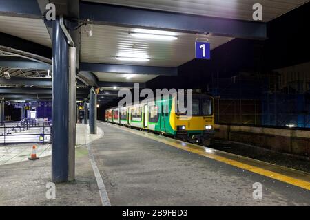 In London Midland livery but now operated by Northern rail class 150 sprinter train 150107at  Blackburn railway station on a dark night Stock Photo