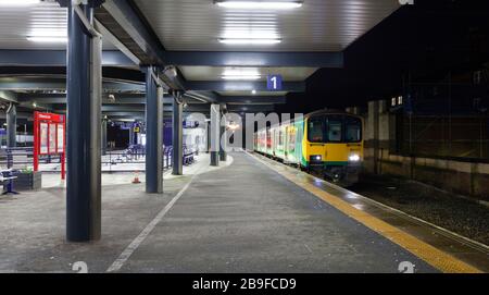 In London Midland livery but now operated by Northern rail class 150 sprinter train 150107at  Blackburn railway station on a dark night Stock Photo