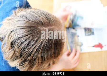 girl doing homework while homeschooling during lockdown dure to pandemic Stock Photo