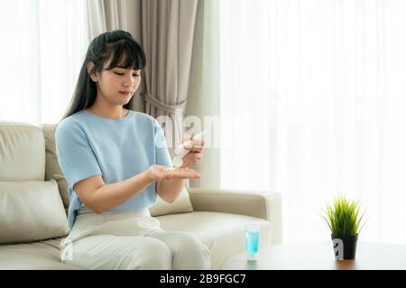 Asian woman using lotion or moisturize as hand of their daily life for protection skin to become dry and irritated after using alcohol antiseptic gel, Stock Photo