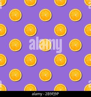 Orange slices seamless pattern on purple background. Minimal flat lay top view food texture. seamless background of fresh orange slices Stock Photo