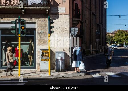 Nuns wait to cross the street in Verona, Italy Stock Photo