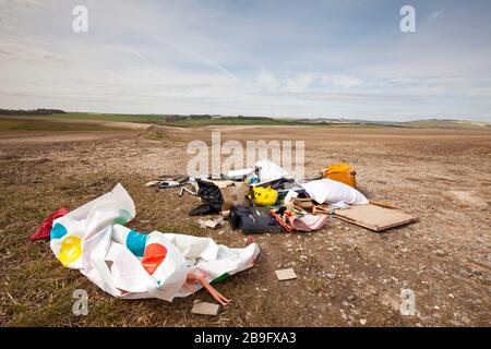 An example of fly tipping in a roadside field on the Wiltshire Downs near Warminster. Stock Photo