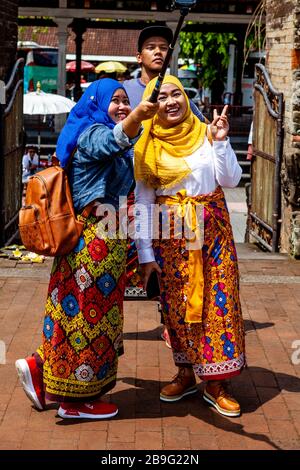 Visitors Taking a Selfie At Pura Puseh Temple, Batuan, Bali, Indonesia. Stock Photo