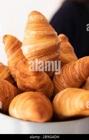 Close up fresh croissants in bowl Stock Photo