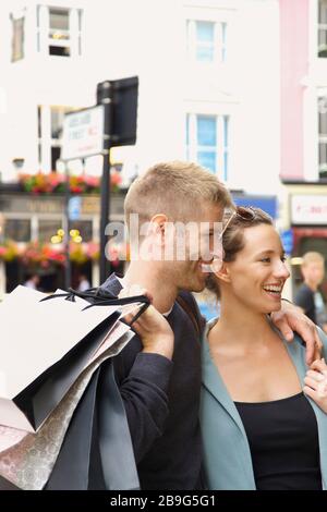 Happy couple shopping in city Stock Photo