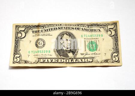 old five dollar bill on a white background isolate Stock Photo