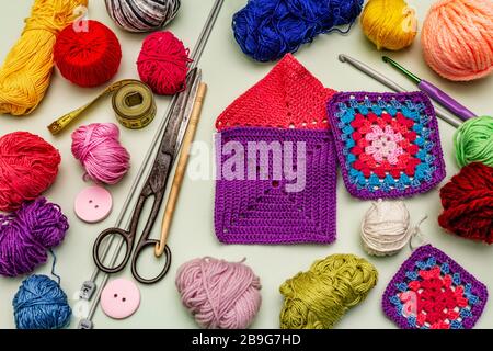 Handmade, DIY concept. Set of tools and materials for knitting. Stay at home in quarantine. Wooden boards background Stock Photo