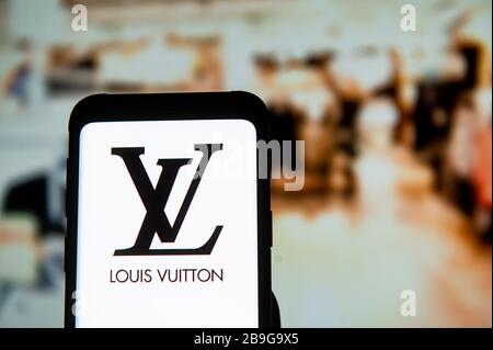 Spain. 11th Mar, 2022. In this photo illustration a Louis Vuitton logo seen  displayed on a smartphone with a Louis Vuitton logo in the background.  (Credit Image: © Thiago Prudencio/SOPA Images via