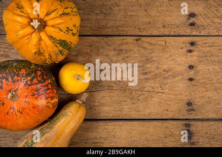 Helloween pumpkins over an old rustic vintage table - top view, copy space Stock Photo