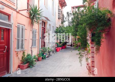 Amazing narrow streets of popular destination on Crete island. Sunny morning in Greece. Traditional architecture and colors of mediterranean city. Pla Stock Photo