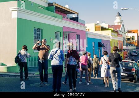 Crowd of tourists visiting vibrant and unique Bo Kaap muslim district of Cape Town South Africa Stock Photo