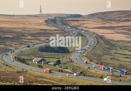 Traffic on the M62 passes Stott Hall farm near Booth Wood in West Yorkshire, the day after Prime Minister Boris Johnson put the UK in lockdown to help curb the spread of the coronavirus. Stock Photo