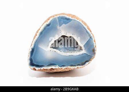 Blue colored geode outside looking like usual rock inside full of tiny crystals Stock Photo