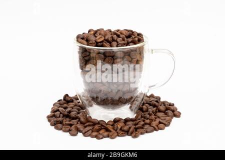 Glass thermos insulating cup transparent filled with and between coffee bean Stock Photo