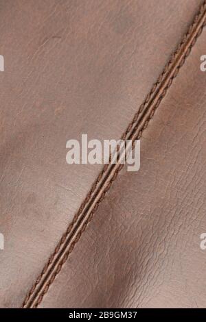 Stitched seam in natural brown and shiny cow skin leather Stock Photo