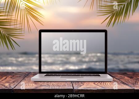 Laptop screen with blurred sea background. Stock Photo