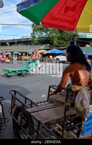 Porters and rickshaw riders in the streets of the Carbon public market. Stock Photo