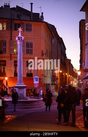 Place des Augustins Town Square & Fontaine des Augustins (1620) Street Fountain & Roman Column at Night or Dusk  Aix-en-Provence Provence France Stock Photo