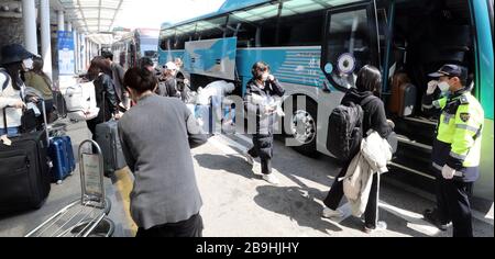 (200324) -- SEOUL, March 24, 2020 (Xinhua) -- Passengers from Europe queue to take buses to leave for quarantine facilities at Incheon International Airport, in Incheon, South Korea, March 24, 2020. South Korea reported 76 more cases of COVID-19 compared to 24 hours ago as of midnight Tuesday local time, raising the total number of infections to 9,037. The newly confirmed cases stayed below 100 for the third straight day. Of the new cases, 20 were imported from abroad. (Newsis/Handout via Xinhua) Stock Photo