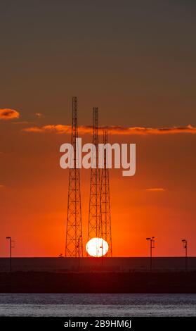 Three radio transmitters at sunrise at Orford Ness, on the former Cobra Mist site. Stock Photo