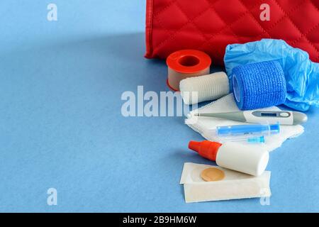 Medical first aid kit with medicaments closeup. Flat lay, blue background. Stock Photo