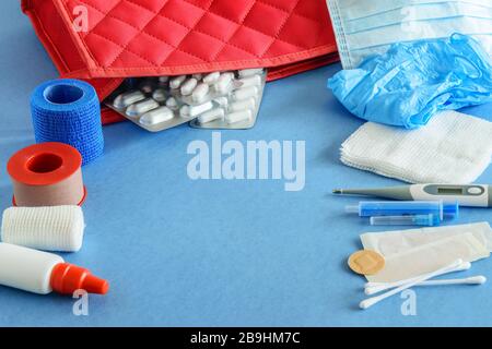 Minimum set of first aid kit on the blue background closeup. Flat  lay. Stock Photo
