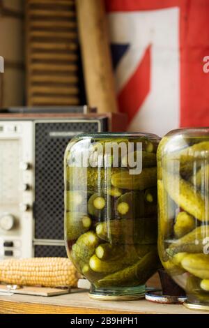 Pickles cucumbers in jars on rustic backgroud. Homemade preserved cucumbers Stock Photo