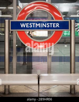 Westminster tube station sign. London Underground roundel on the platform at Westminster tube station on the Jubilee Line. Stock Photo