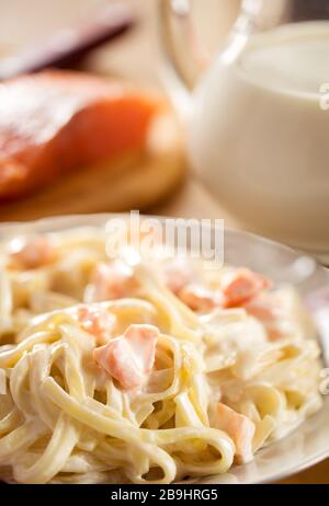 Tasty spaghetti with salmon. Tagliatelle pasta with cream and salmon sauce. Shallow depth of field Stock Photo