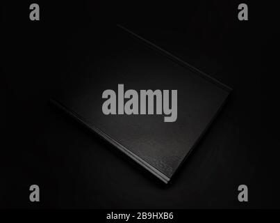 Black leather folder isolated on black background. With clipping path Stock Photo