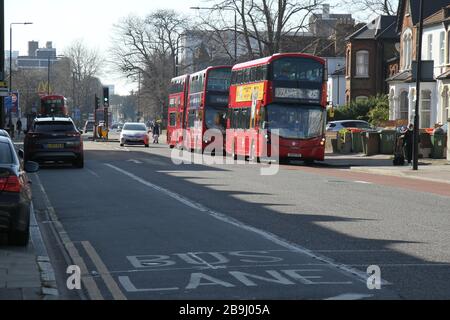 London, UK - 24 March 2020: A TFL bus plying between the city and Ilford at a bus sopn on Romford Road. Romford Road was virtually empty but for essential services, a day after the Uk was put on lockdown due to the Coronavirus spread. The government has adviced the the public to stay at home across the UK due to the Covid-19 pandemic. Photos: David Mbiyu/ Alamy Live News Stock Photo