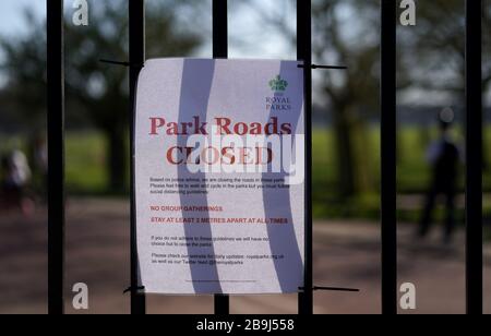 A sign regarding social distancing on the gates of Richmond Park, the day after Prime Minister Boris Johnson put the UK in lockdown to help curb the spread of the coronavirus. Stock Photo