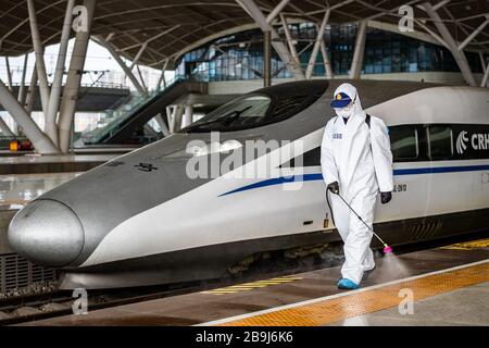 (200324) -- WUHAN, March 24, 2020 (Xinhua) -- A firefighter conducts disinfection on the platform of Wuhan Railway Station in Wuhan, central China's Hubei Province, March 24, 2020.  Over 70 firefighters conducted a comprehensive disinfection at the railway station on Tuesday. (Photo by He Hanqiu/Xinhua) Stock Photo