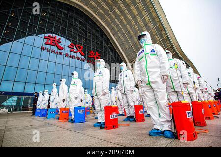 (200324) -- WUHAN, March 24, 2020 (Xinhua) -- Firefighters gather to prepare for disinfection works at the Wuhan Railway Station in Wuhan, central China's Hubei Province, March 24, 2020.  Over 70 firefighters conducted a comprehensive disinfection at the railway station on Tuesday. (Photo by He Hanqiu/Xinhua) Stock Photo
