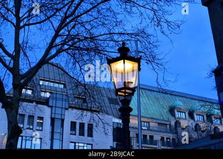 Old lantern in front of old buildings in downtown Düsseldorf in the afternoon. Stock Photo